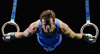Gymnast holding position on the rings